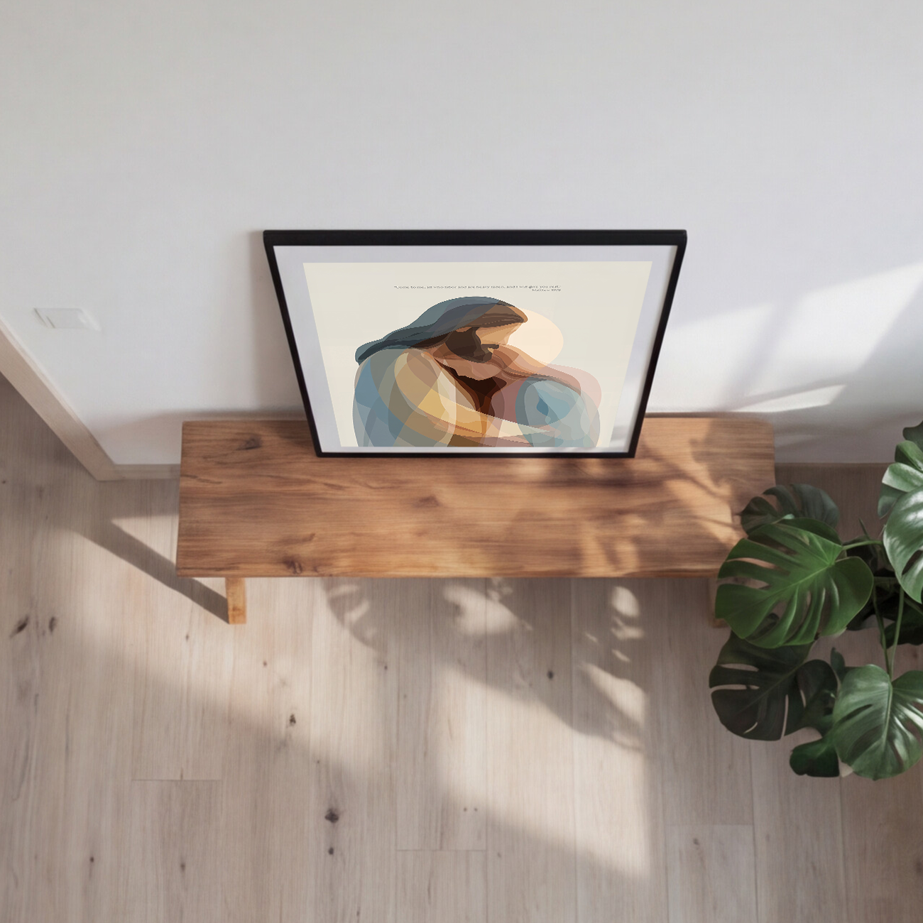 Framed artwork on a wooden shelf with a plant in the corner