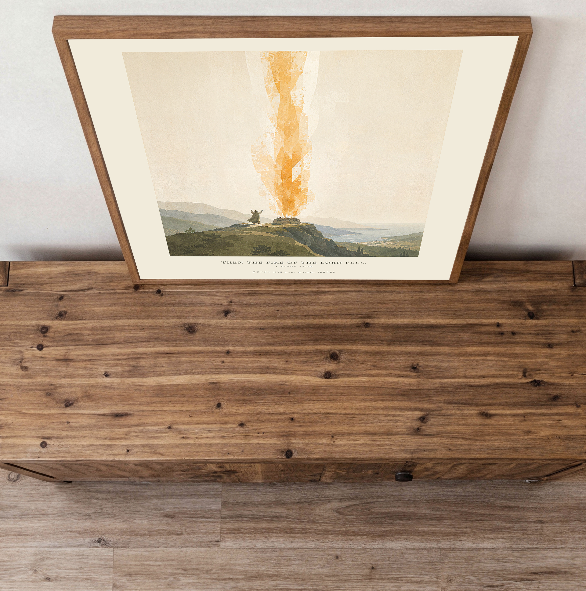 Framed artwork on a wooden surface with a white wall background