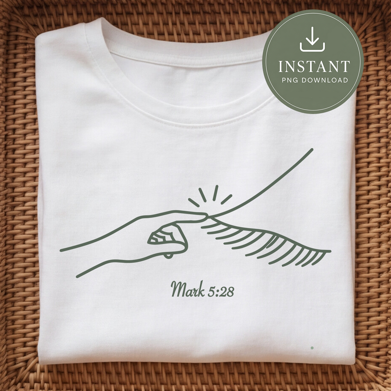 A folded white T-shirt laid flat on a woven brown wicker surface, featuring a dark green line drawing of a hand touching grass with the text 'Mark 5:28' below. A round green badge in the top right says 'INSTANT PNG DOWNLOAD'.