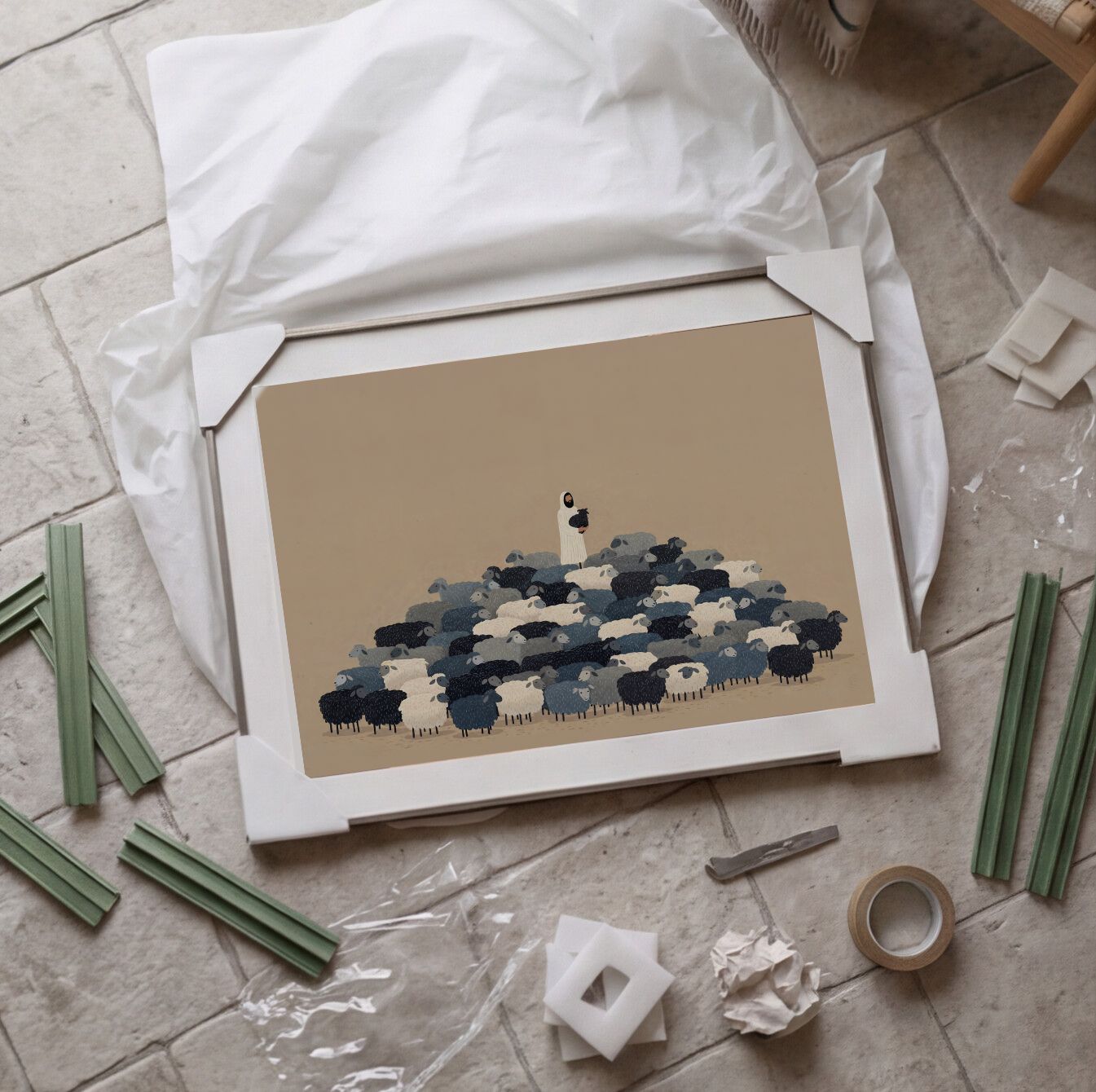 A framed art print featuring a minimalist illustration of a shepherd with a flock of sheep in shades of blue, white, and black on a beige background, enclosed in a silver frame with a white mat.